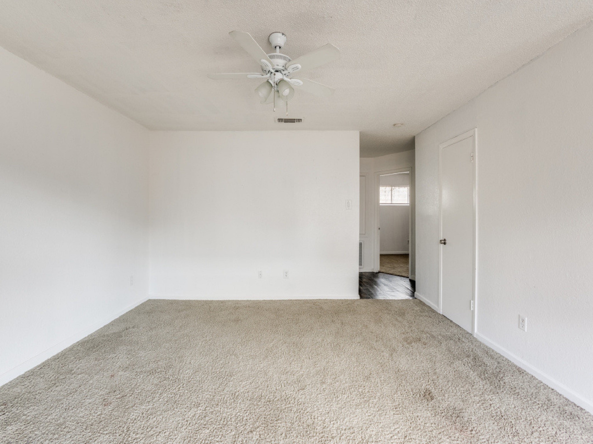 1711 Wichita Street, Unit 8 Houston, TX 77004 - Photo 5 of 12 a view of an empty room with a chandelier fan