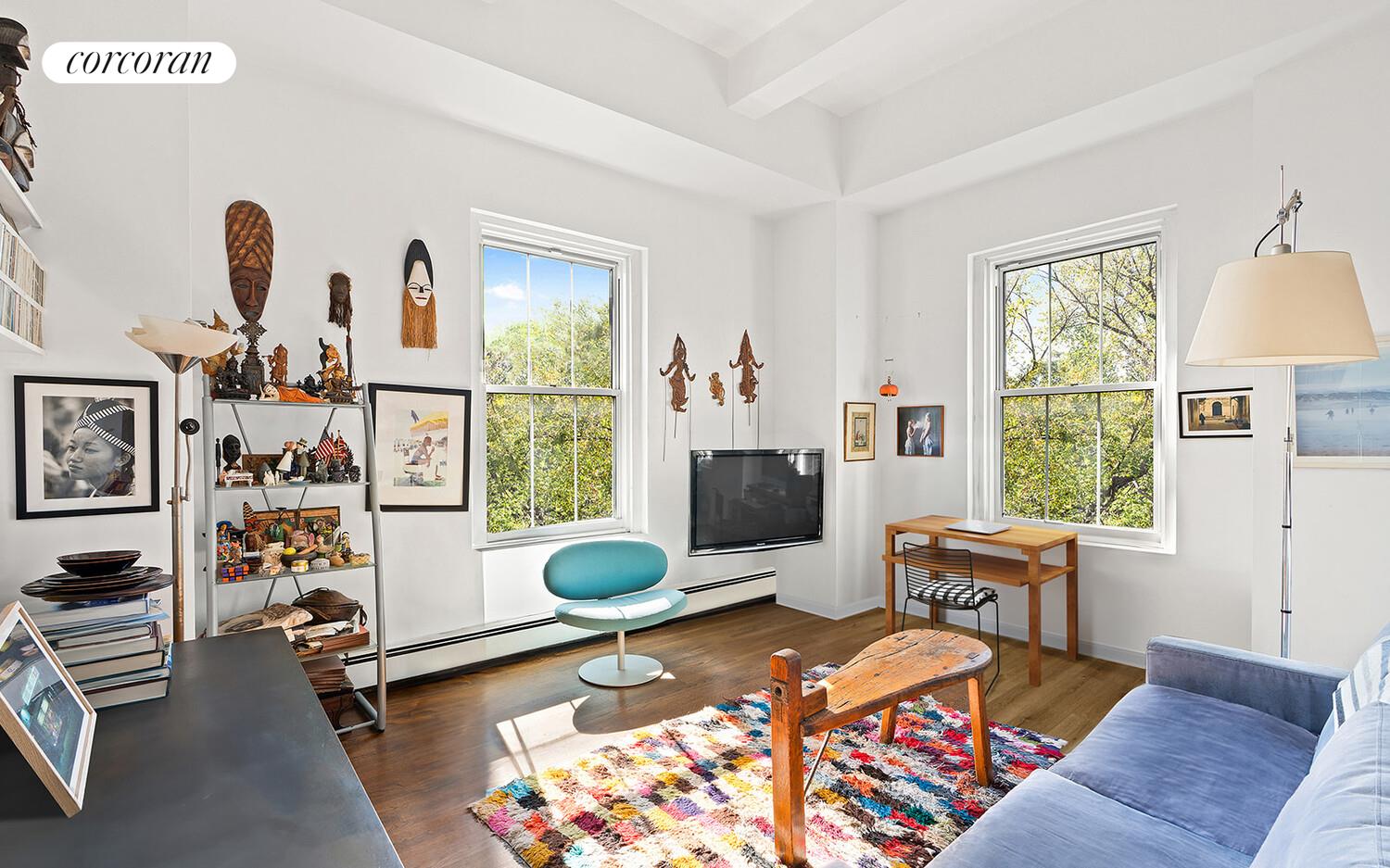a living room with furniture a flat screen tv and a window