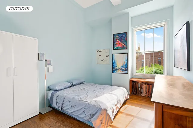 a room with lots of books and a baby crib