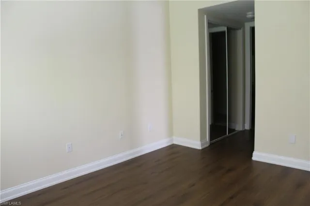 a view of a small space with wooden floor and a window