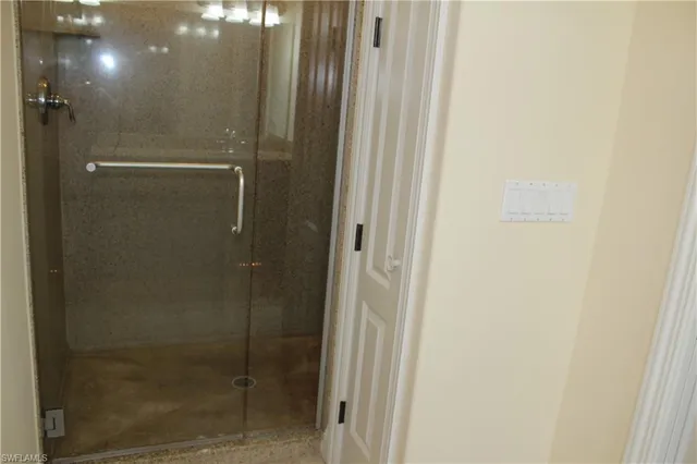 a bathroom with a glass shower door