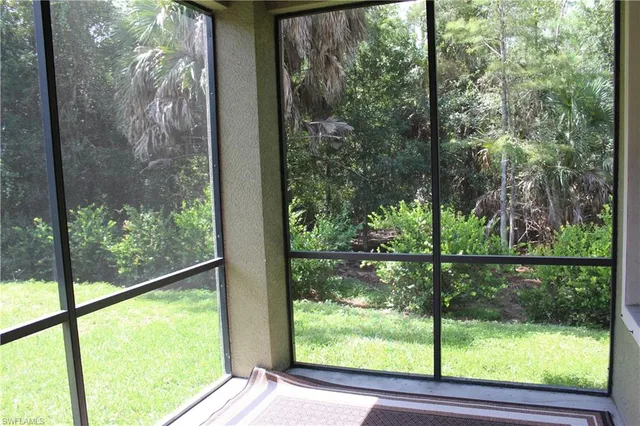 a view of a room with a large window and front door