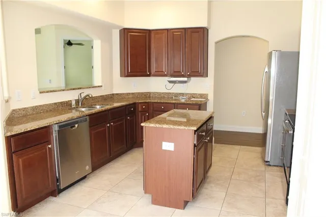 a kitchen with a stove sink and cabinets