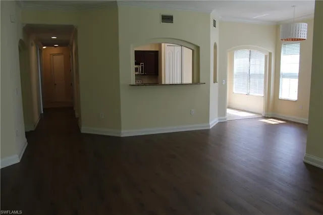 a view of a room with wooden floor and window