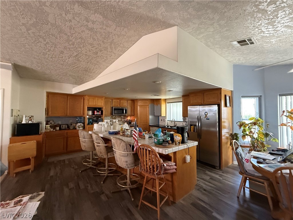 2171 South Blagg Road Pahrump, NV 89048 - Photo 8 of 27 An inviting open-concept kitchen features a spacious island for casual dining and durable wood-look flooring.