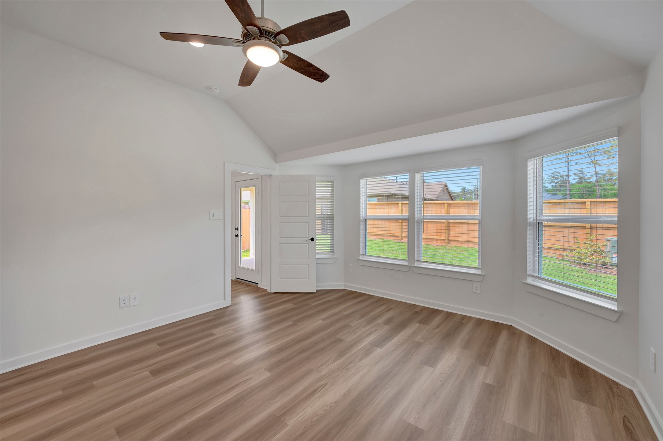 759 Hackberry Branch Magnolia, TX 77354 - Photo 4 of 43 a view of an empty room with a window and wooden floor