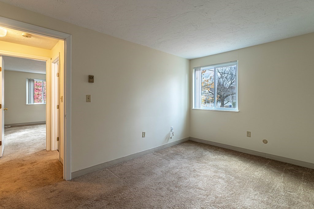 10 Mill Street, Unit X Maynard, MA 01754 - Photo 11 of 16 an empty room with windows and closet