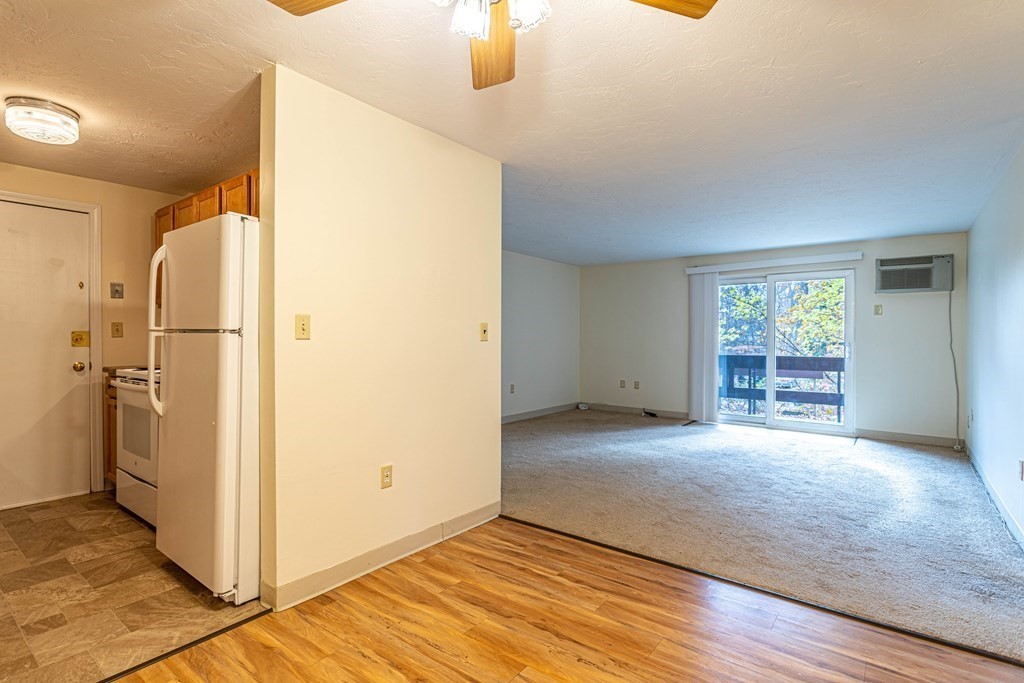 10 Mill Street, Unit X Maynard, MA 01754 - Photo 4 of 16 a view of empty room with wooden floor and fan