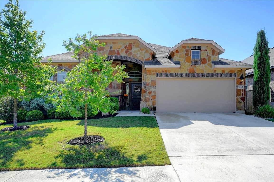 a front view of a house with a yard