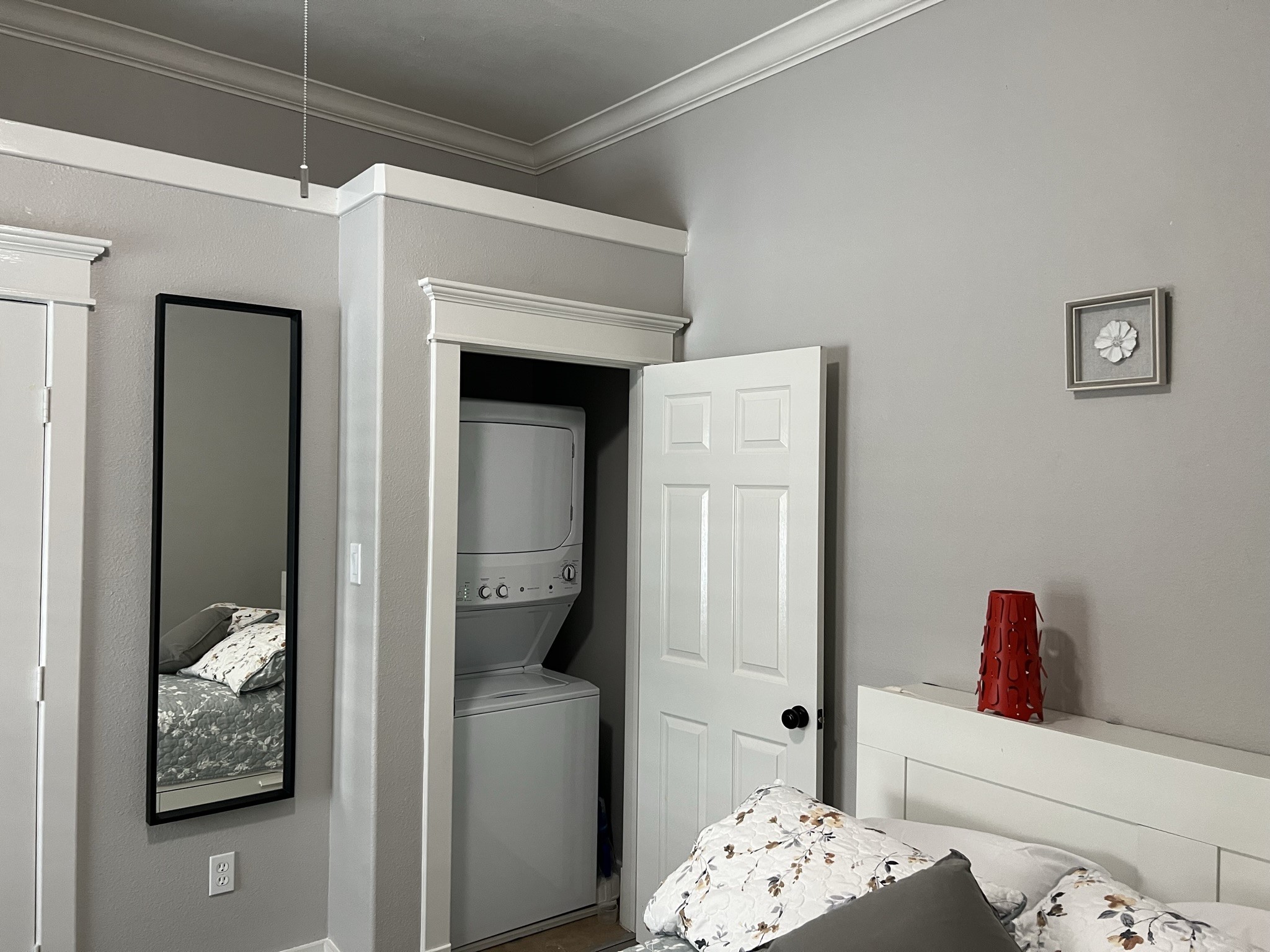 220 Redan Street, Unit A Houston, TX 77009 - Photo 19 of 22 a bedroom with a bed and a chandelier