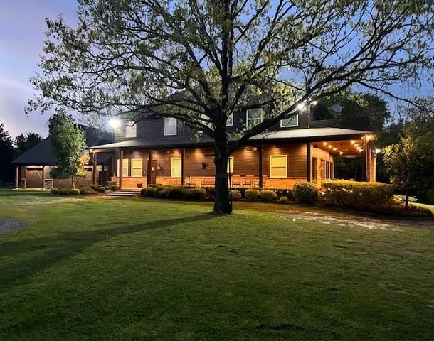 a front view of a house with a garden