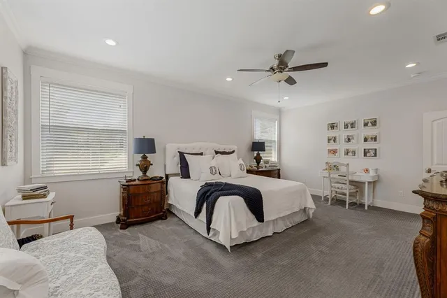 a large white bed sitting in a room next to a window