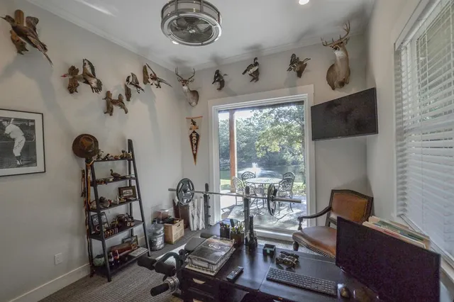 a view of a workspace with furniture and a window