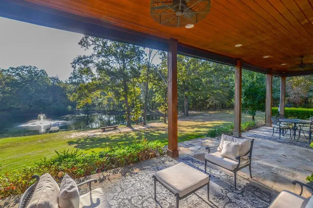 a view of swimming pool with a table and chairs in patio