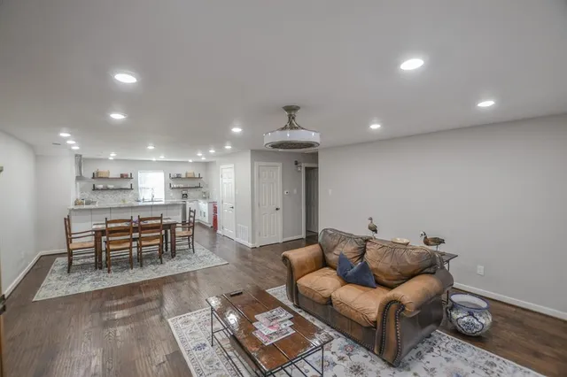 a living room with furniture and kitchen view