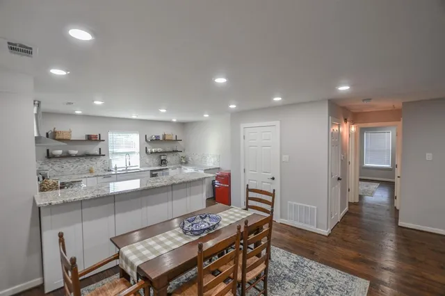 a kitchen with a table and chairs in it