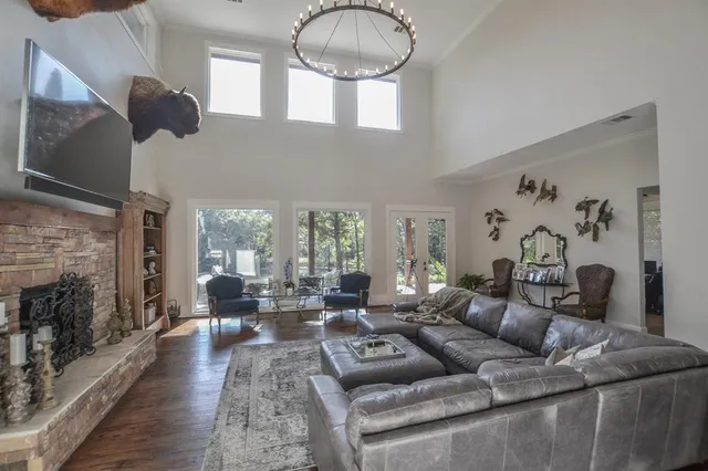 a living room with furniture fireplace and a large window
