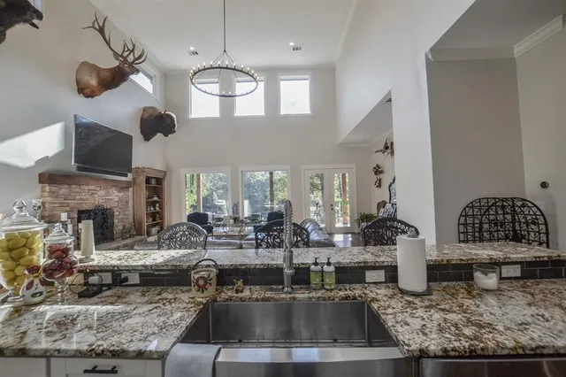 a living room with fireplace furniture and a chandelier