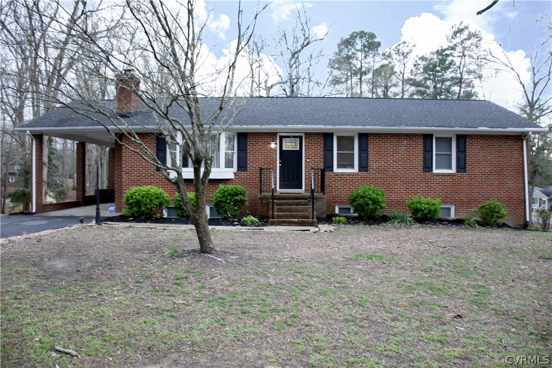 11500 Chester Road Chester, VA 23831 - Photo 1 of 49 a front view of a house with a yard and garage