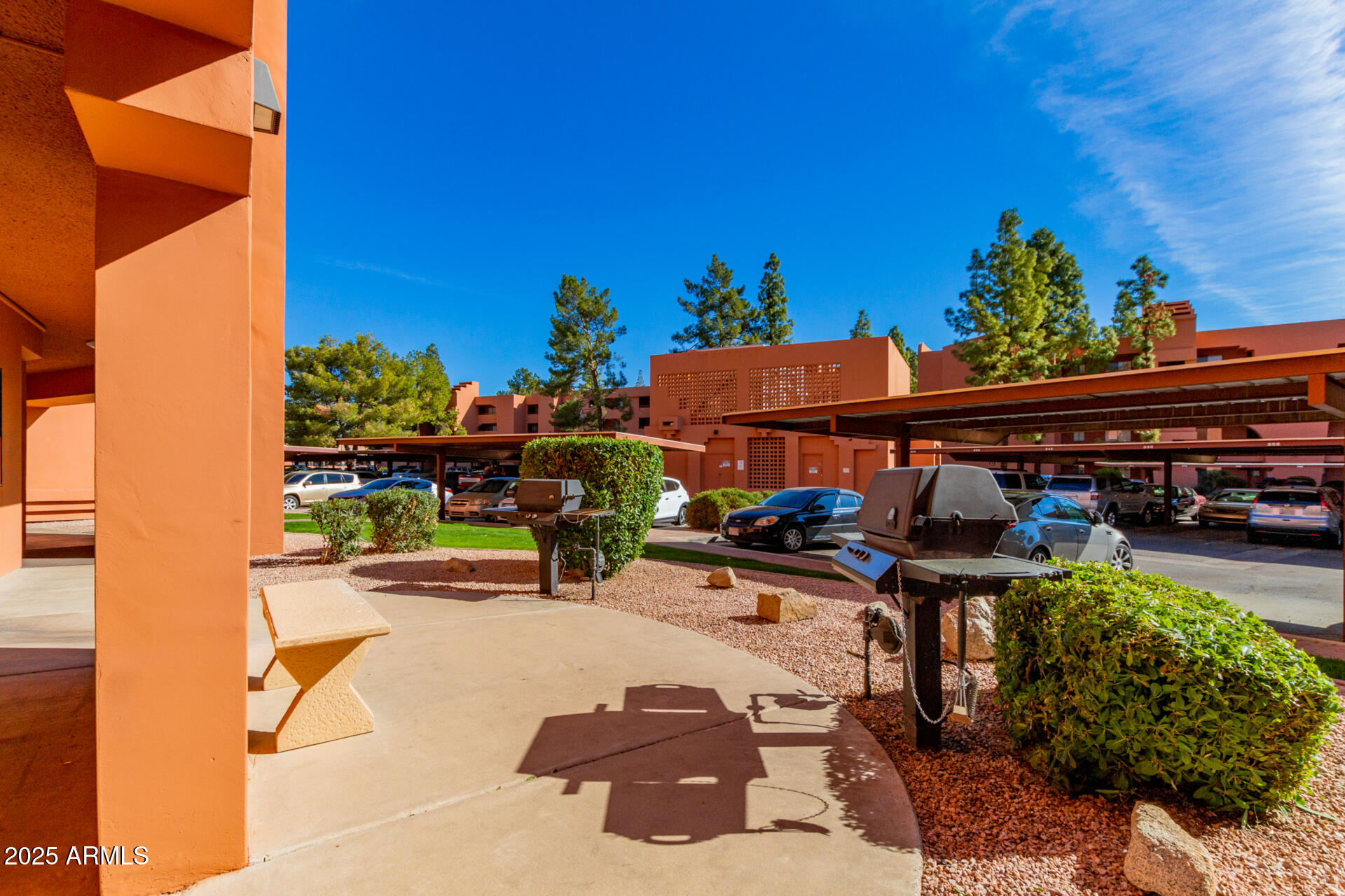 4303 East Cactus Road, Unit 202 Phoenix, AZ 85032 - Photo 31 of 34 a view of a patio with table and chairs under an umbrella