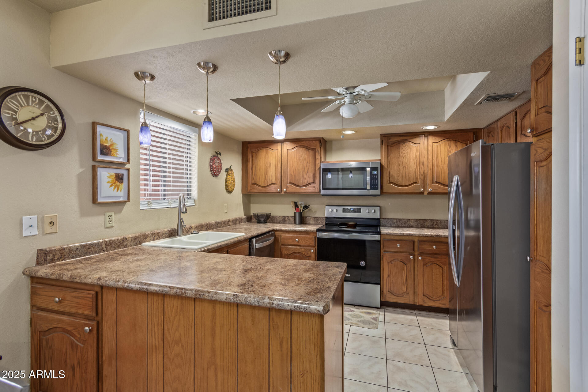 4303 East Cactus Road, Unit 202 Phoenix, AZ 85032 - Photo 4 of 34 a kitchen with stainless steel appliances granite countertop a sink and a refrigerator