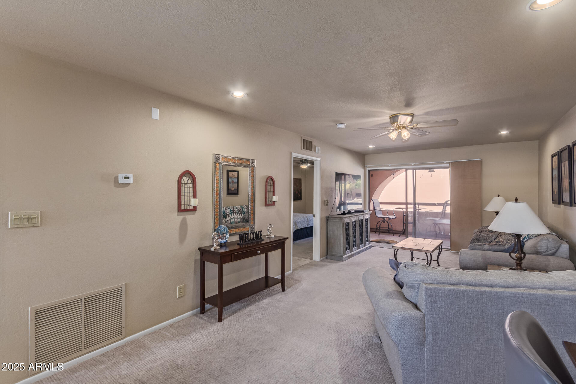 4303 East Cactus Road, Unit 202 Phoenix, AZ 85032 - Photo 6 of 34 a living room with furniture and a chandelier