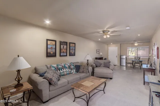 a kitchen with stainless steel appliances granite countertop a sink refrigerator and cabinets