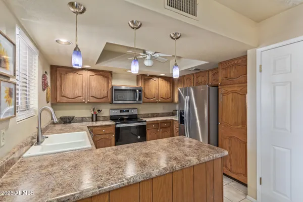 a kitchen with stainless steel appliances granite countertop a sink and a stove
