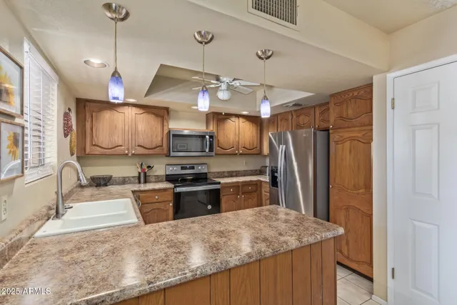 a kitchen with stainless steel appliances granite countertop a sink and a stove