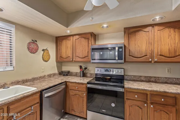 a bathroom with a granite countertop sink a large mirror and a window