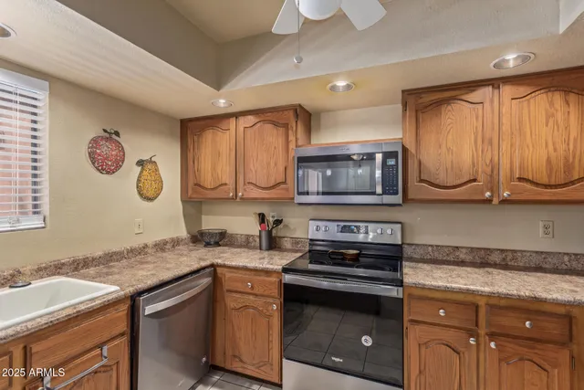 a bathroom with a granite countertop sink a large mirror and a window