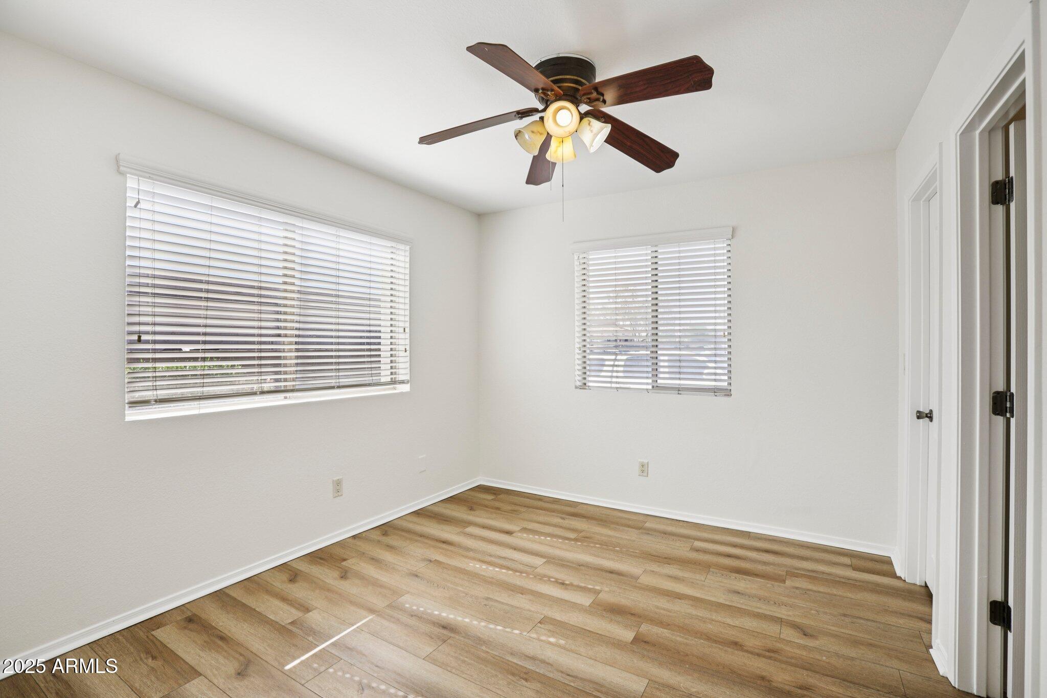 303 North Miller Road, Unit 1001 Scottsdale, AZ 85257 - Photo 16 of 20 a view of empty room with wooden floor and fan