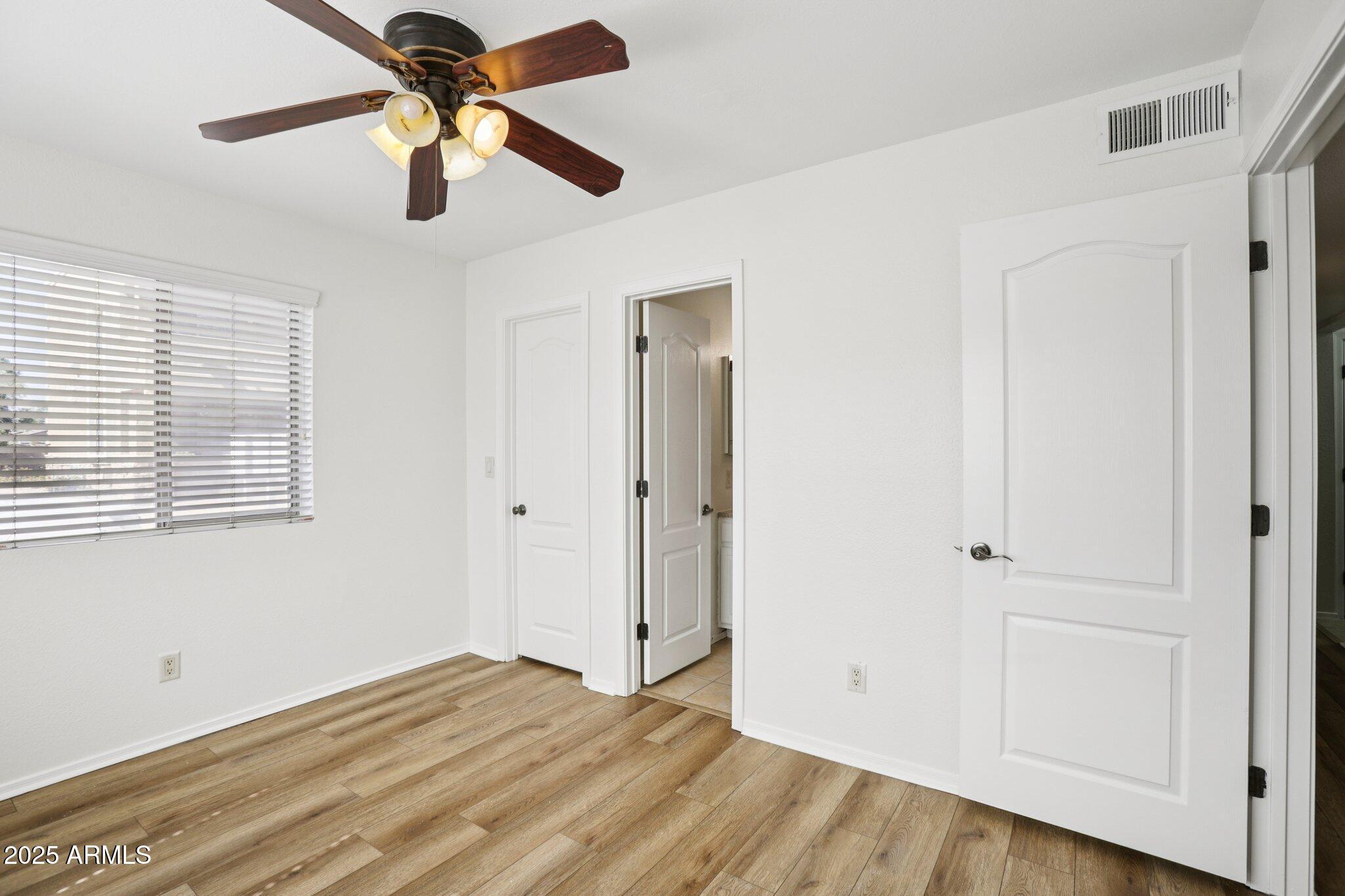 303 North Miller Road, Unit 1001 Scottsdale, AZ 85257 - Photo 17 of 20 a view of empty room with wooden floor