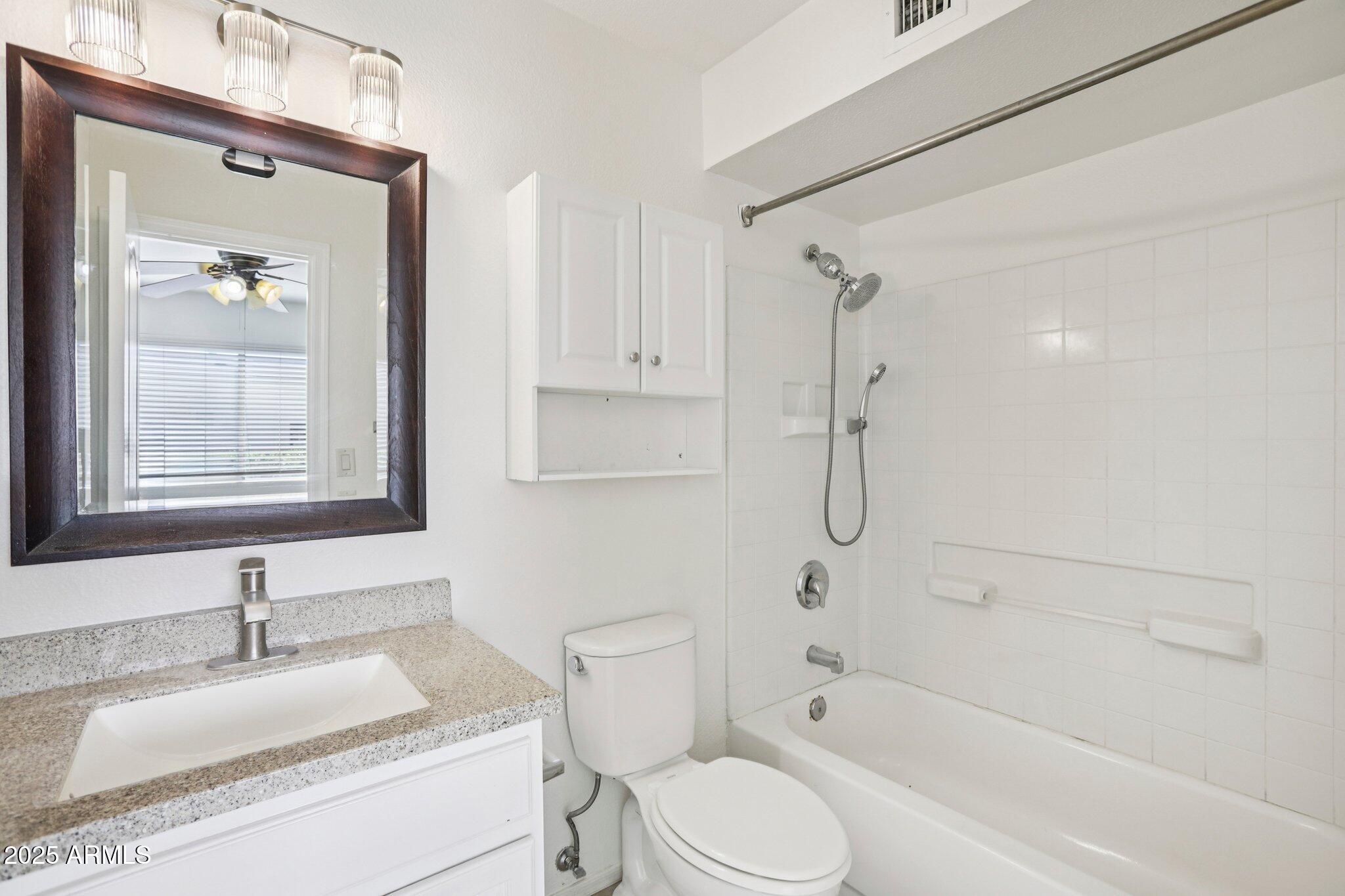 303 North Miller Road, Unit 1001 Scottsdale, AZ 85257 - Photo 19 of 20 a bathroom with a granite countertop sink toilet and shower