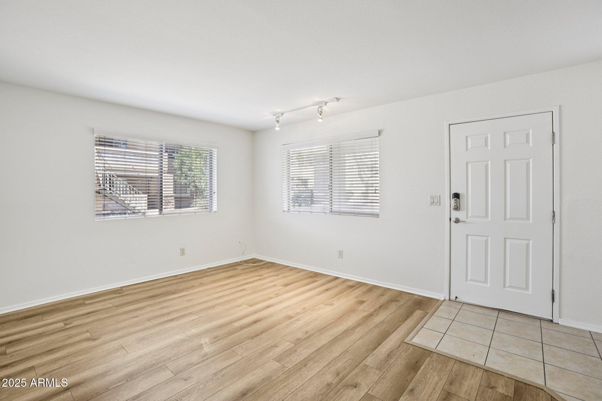 303 North Miller Road, Unit 1001 Scottsdale, AZ 85257 - Photo 5 of 20 wooden floor in an empty room with a window