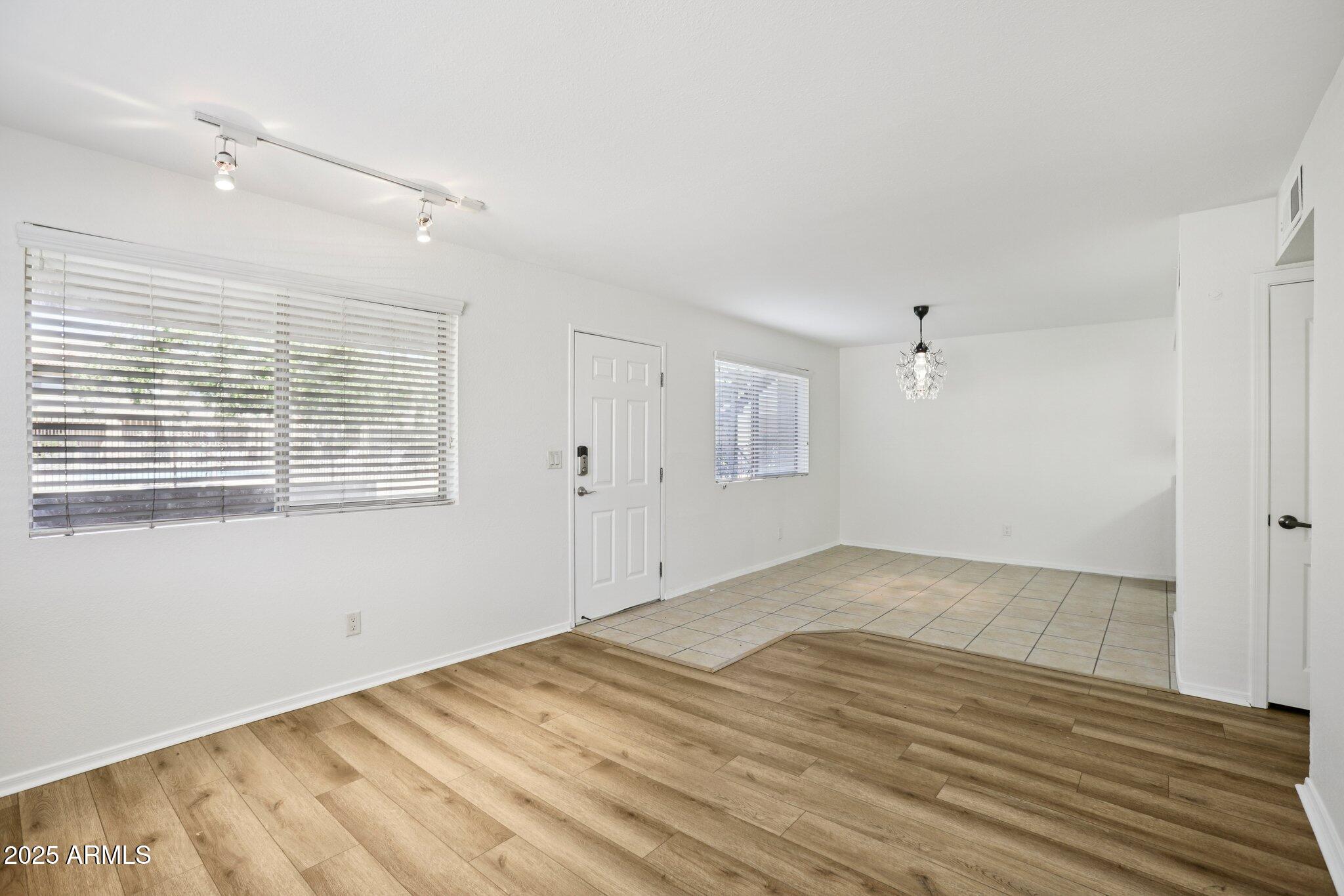 303 North Miller Road, Unit 1001 Scottsdale, AZ 85257 - Photo 6 of 20 a view of empty room with wooden floor and fan