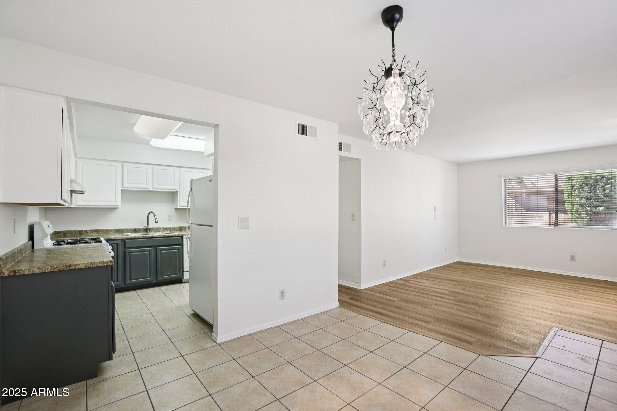 303 North Miller Road, Unit 1001 Scottsdale, AZ 85257 - Photo 8 of 20 a kitchen with stainless steel appliances granite countertop a stove a sink and a refrigerator