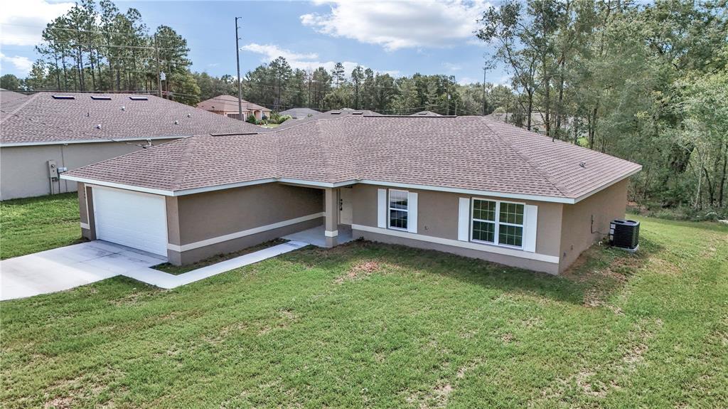 8040 Southwest 131st Lane Ocala, FL 34473 - Photo 2 of 39 a aerial view of a house with a yard and large tree