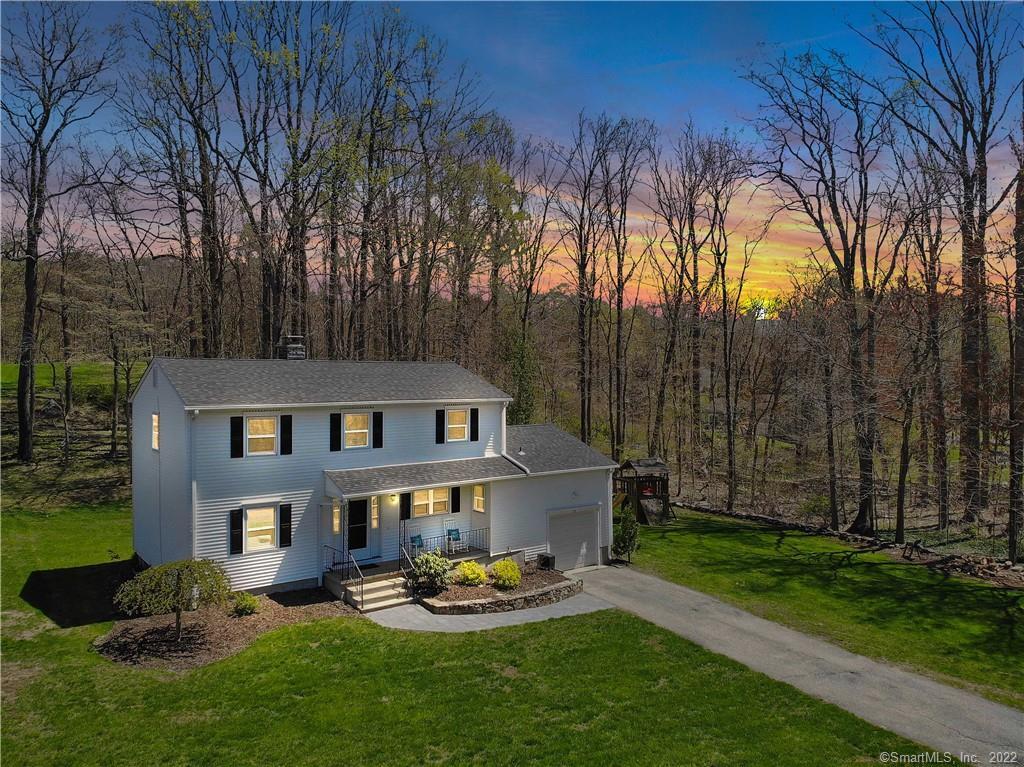 15 Toll Gate Road Monroe, CT 06468 - Photo 1 of 1 a backyard of a house with garden and outdoor seating