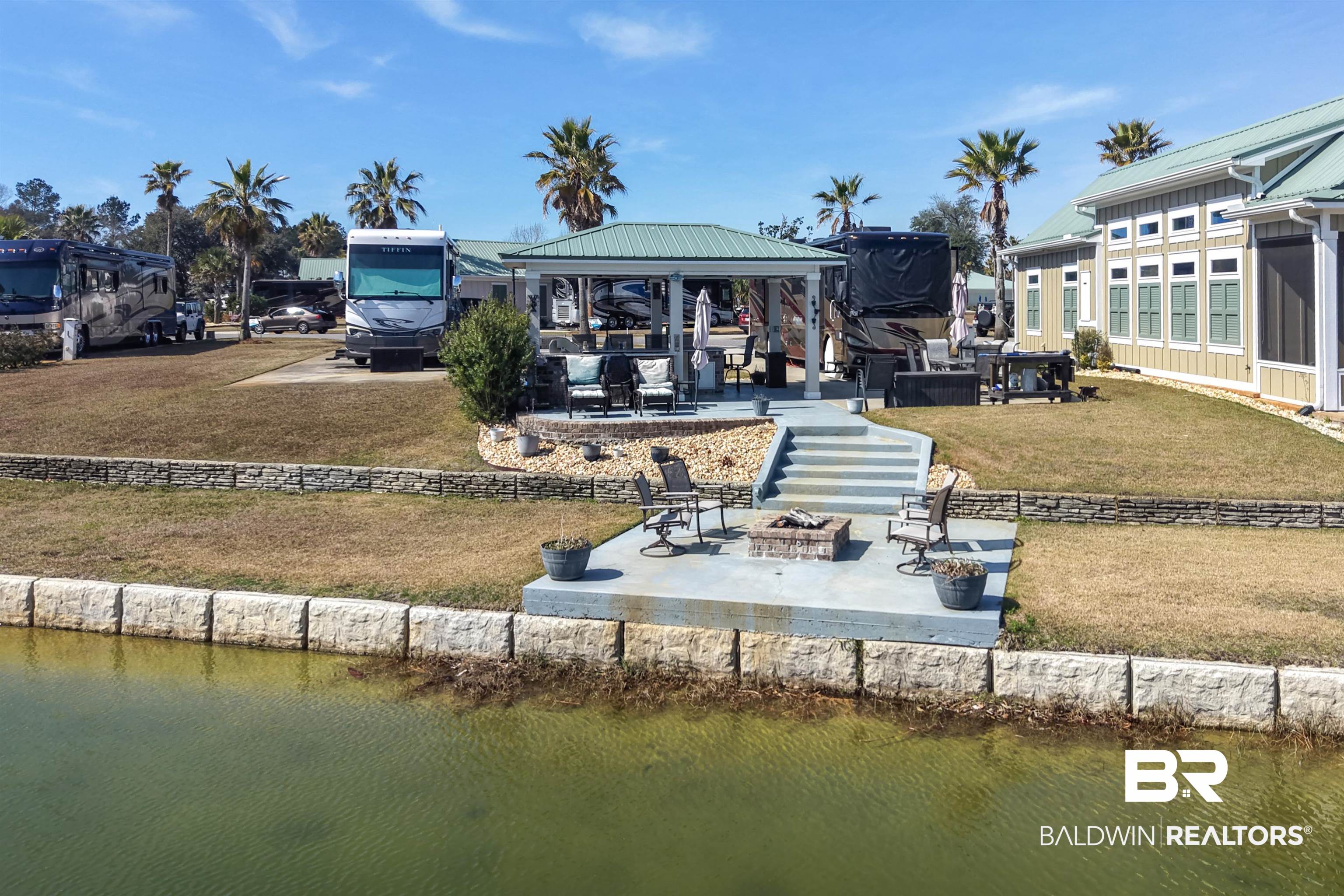 11996 Raptor Court Elberta, AL 36530 - Photo 15 of 45 Back of house with a fire pit, a gazebo, a water view, and a patio