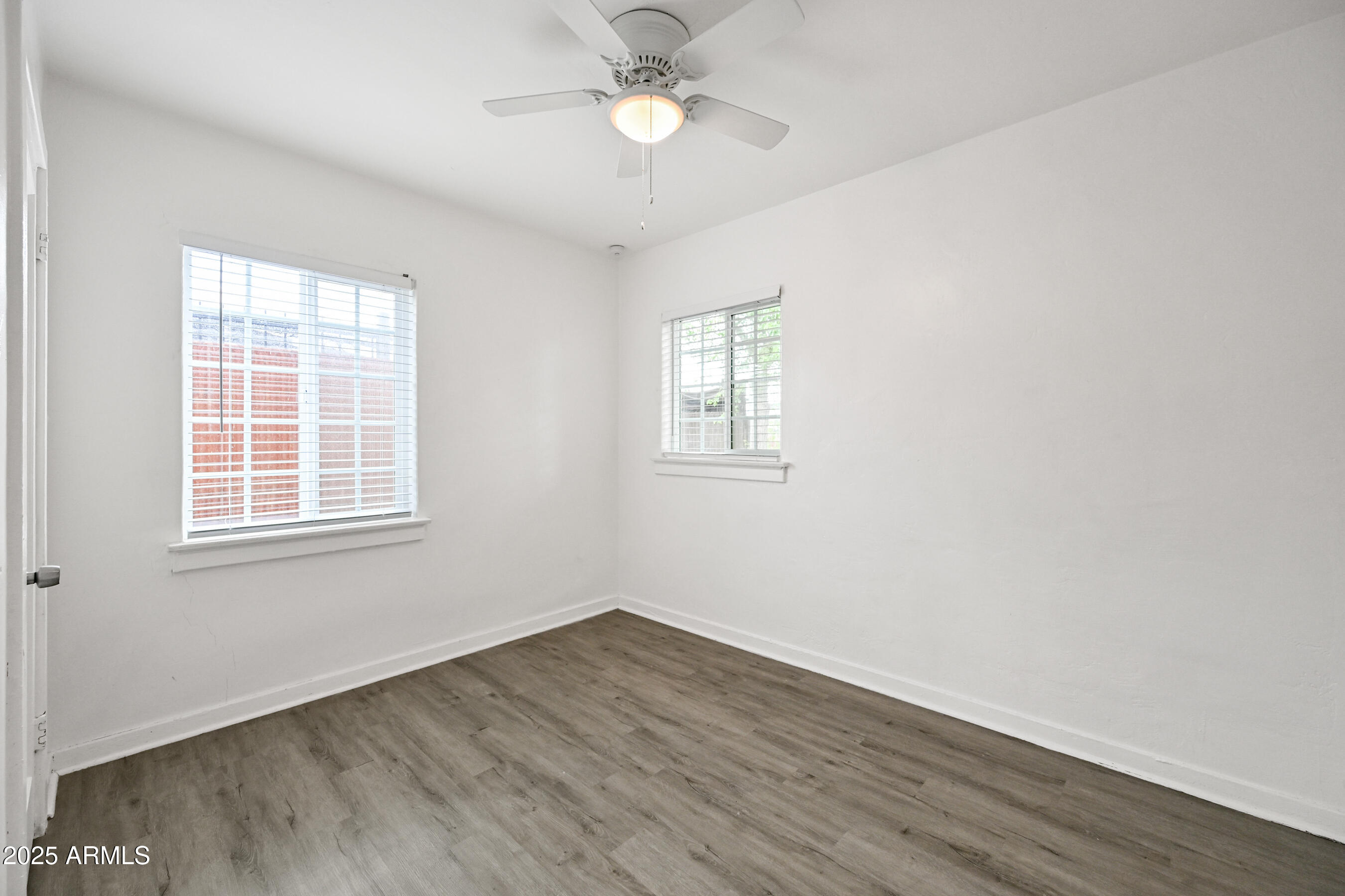 2709 North 7th Street Phoenix, AZ 85006 - Photo 13 of 14 wooden floor in an empty room with a window