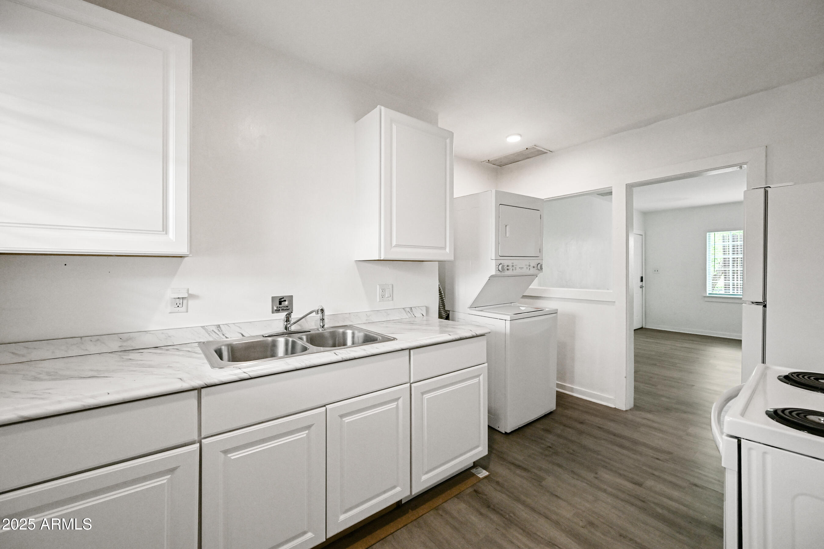 2709 North 7th Street Phoenix, AZ 85006 - Photo 10 of 14 a kitchen with white cabinets white appliances sink and dishwasher