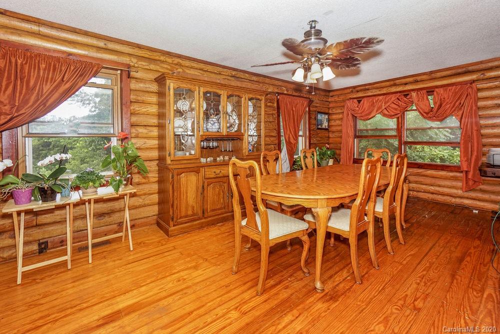 1471 J J Rhyne Reep Road Vale, NC 28168 - Photo 17 of 43 a dining room with wooden floor a chandelier a glass table and chairs