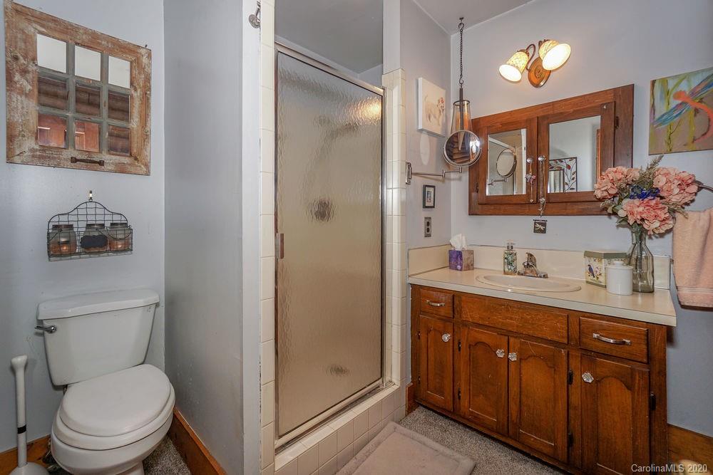 1471 J J Rhyne Reep Road Vale, NC 28168 - Photo 20 of 43 a bathroom with a toilet a sink a vanity a mirror and a shower