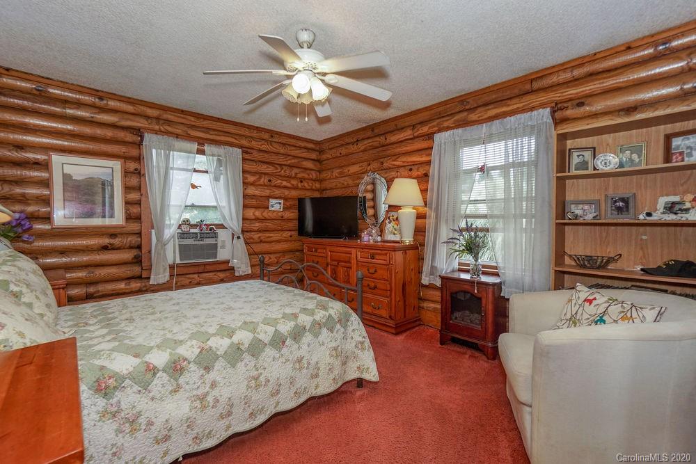 1471 J J Rhyne Reep Road Vale, NC 28168 - Photo 21 of 43 a spacious bedroom with a bed and a chandelier
