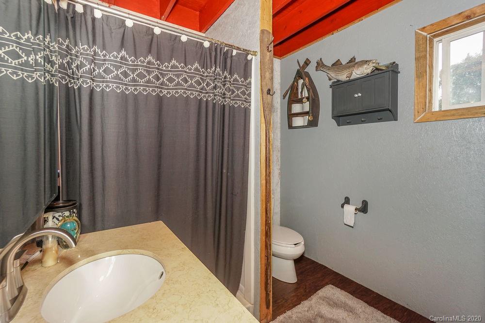 1471 J J Rhyne Reep Road Vale, NC 28168 - Photo 32 of 43 a bathroom with a granite countertop sink and a mirror