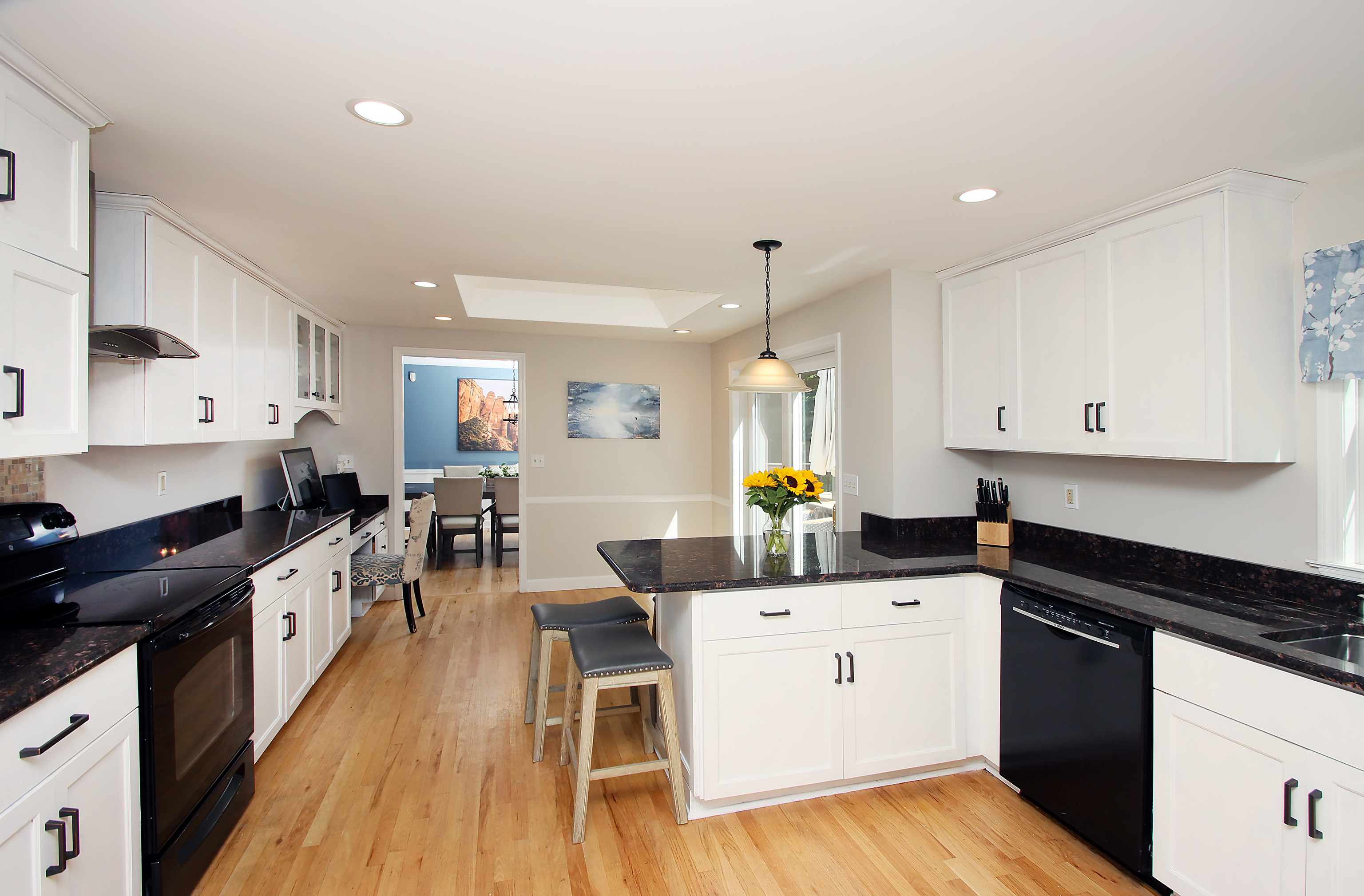 4 Stone Dam Road Bethel, CT 06801 - Photo 3 of 13 a kitchen with a sink stove and white cabinets with wooden floor