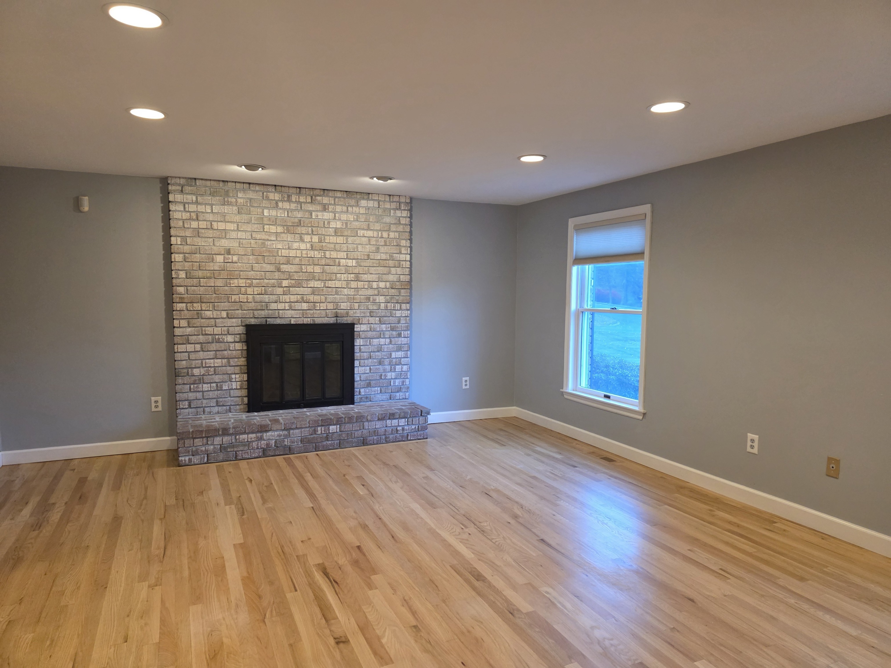 4 Stone Dam Road Bethel, CT 06801 - Photo 7 of 13 an empty room with wooden floor and fireplace