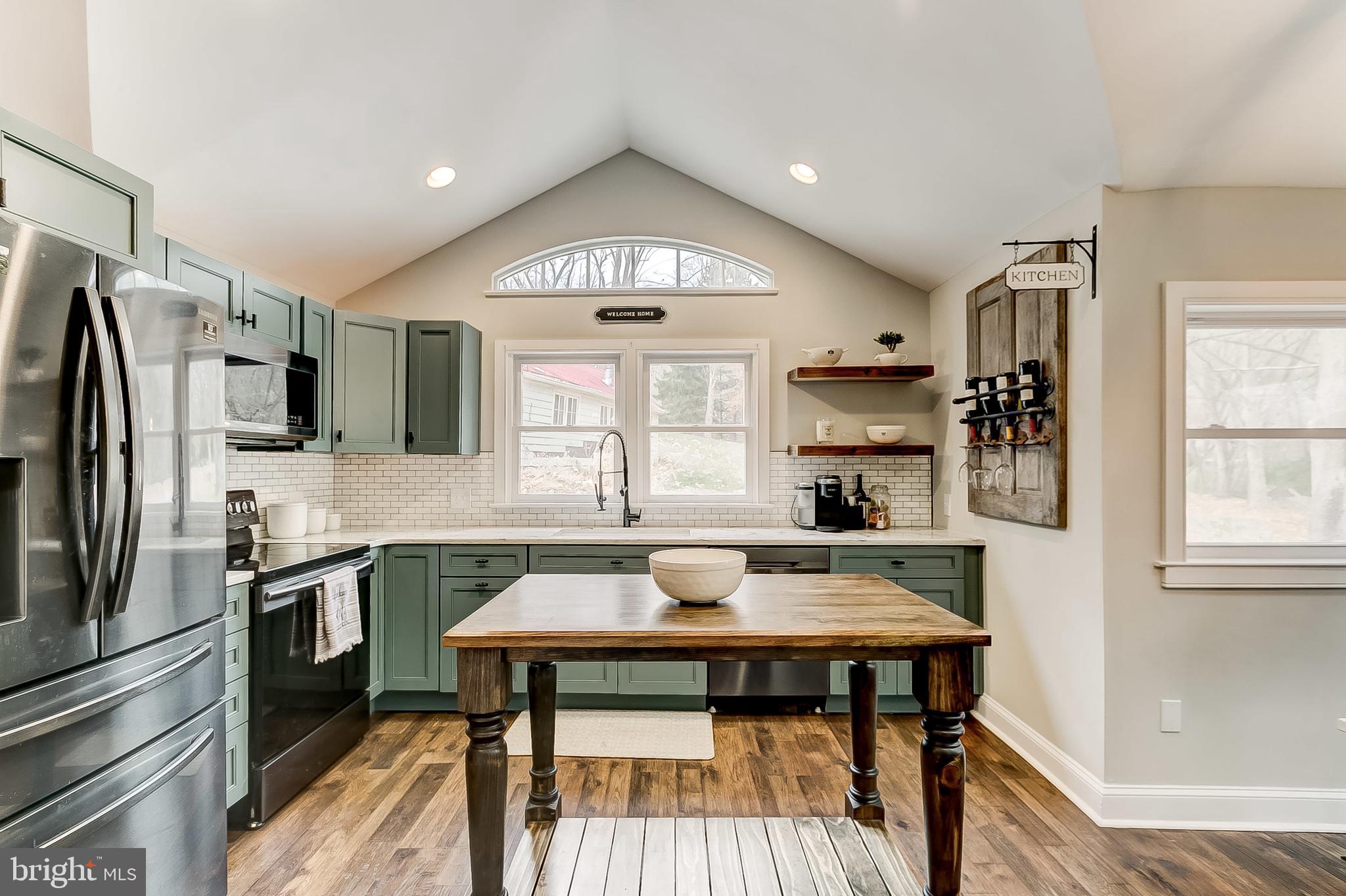 2812 Cape Horn Road Westminster, MD 21157 - Photo 7 of 40 a kitchen with a table chairs refrigerator and microwave