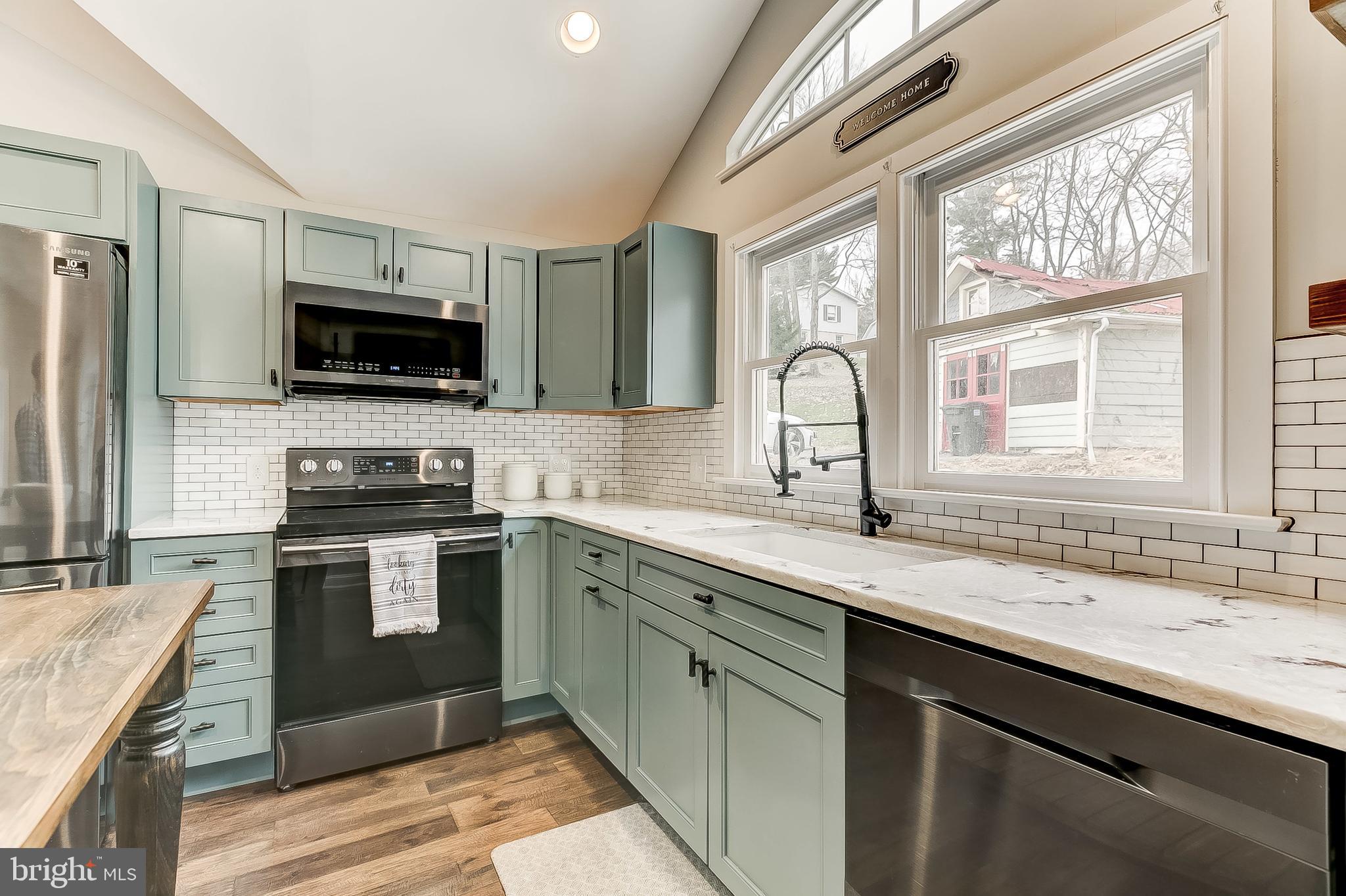 2812 Cape Horn Road Westminster, MD 21157 - Photo 8 of 40 a kitchen with a sink stove and microwave